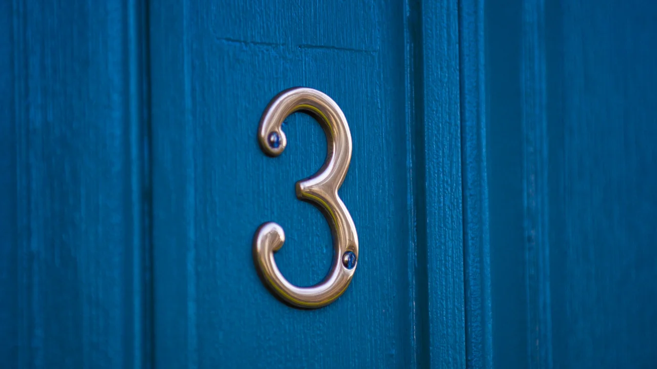 Two mint chocolate milkshakes with whipped cream and green sprinkles.