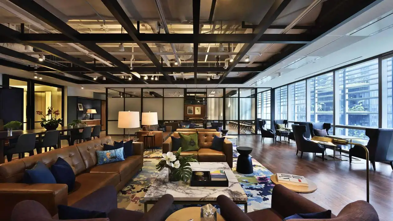 Close up on a plate of mashed potatoes, topped with baked pork chops with cream of mushroom soup, and a side of green beans.