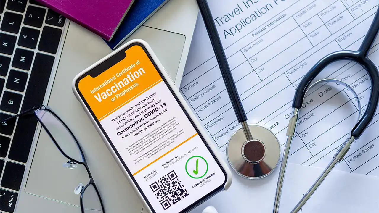 blue bowl of black bean beef tortilla soup on a board with cilantro and shredded cheese in background