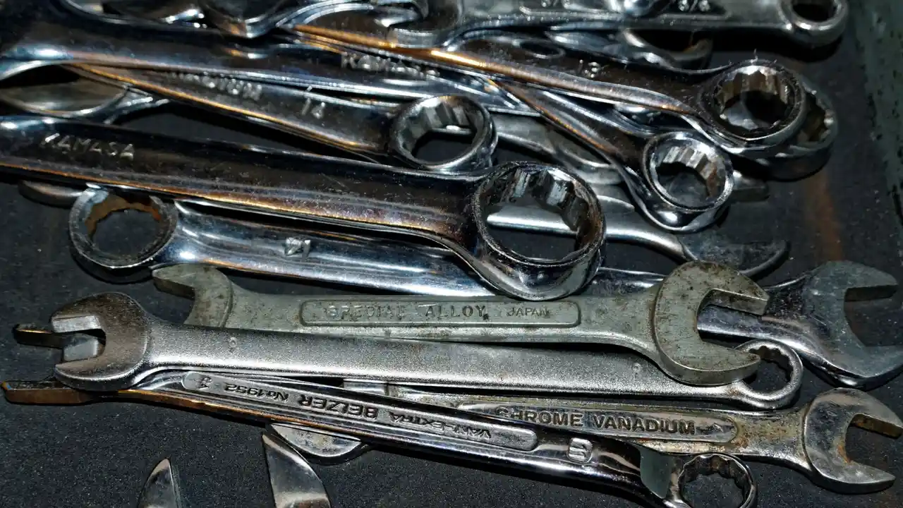 Close up on a plate of mashed potatoes, topped with baked pork chops with cream of mushroom soup, and a side of green beans.