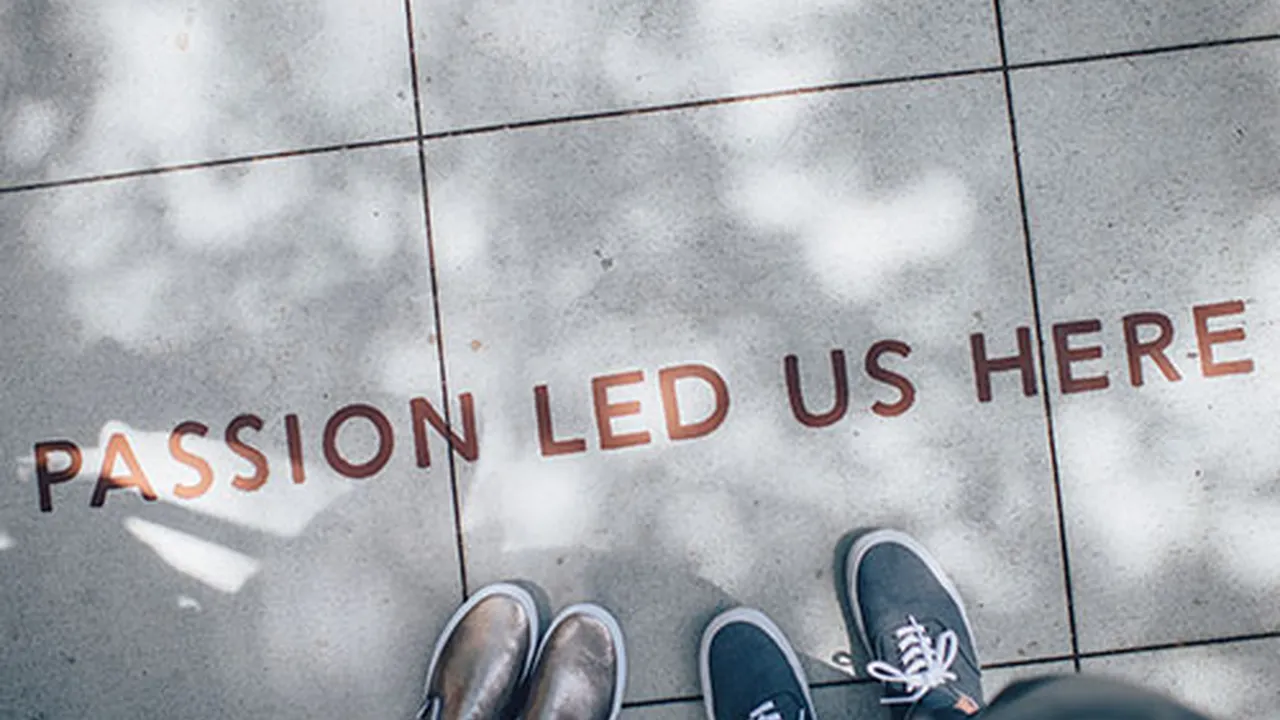 Close up on a plate of mashed potatoes, topped with baked pork chops with cream of mushroom soup, and a side of green beans.